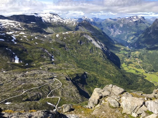 Geiranger, Møre og Romsdal province, Norway, view of a winding road in a deep, green mountain gorge above the Geiranger fjord, highest fjord view in Europe from the Geiranger Skywalk