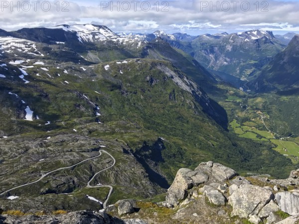 Geiranger, Møre og Romsdal province, Norway, view of a winding road in a deep, green mountain gorge above the Geiranger Fjord, highest fjord view in Europe from the Geiranger Skywalk