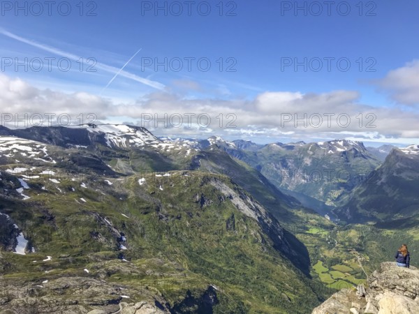 Geiranger, Møre og Romsdal province, Norway, panorama of mountains and green valley under blue sky on Geiranger Fjord, highest fjord view in Europe from the Geiranger Skywalk