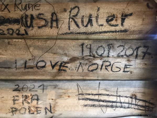 Drevsjø, Innlandet, Norway, wooden wall with graffiti and inscriptions, including countries and dates