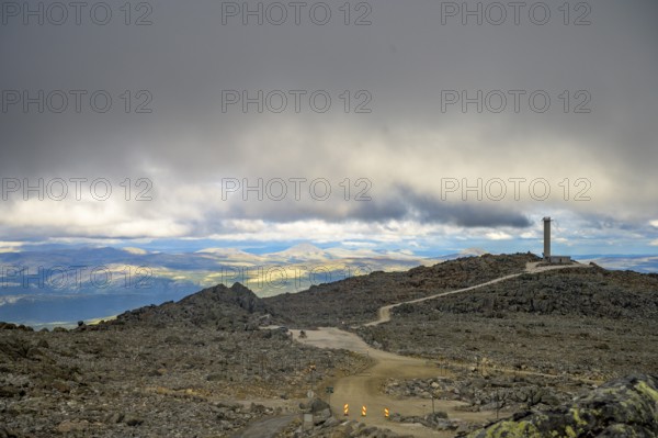 Alvdal, Innlandet, Norway, Extensive view over a rocky plateau under a cloudy sky, road to Tronfellet with an altitude difference of 1161 m the highest passable road in Norway