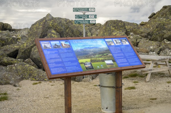 Alvdal, Innlandet, Norway, information board on the hiking route in front of a rocky landscape and signs, road to Tronfellet with an altitude difference of 1161 m the highest navigable road in Norway