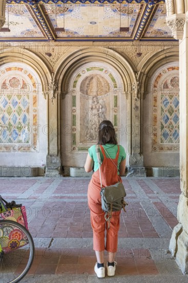 Woman photographs the wall decorations, Bethesda Terrace, Central Park, Manhatten, New York City, USA