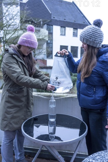Symbolic picture blackout, extensive, prolonged power failure, in the private environment, without electricity, the water supply also fails, rainwater is made drinkable with the help of a water filter