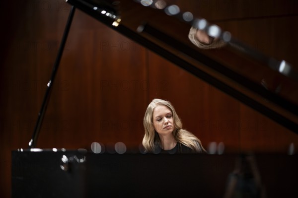Young woman, pianist, with concentrated facial expression and closed eyes playing on a Steinway & Sons grand piano, Stuttgart, Baden-Württemberg, Germany