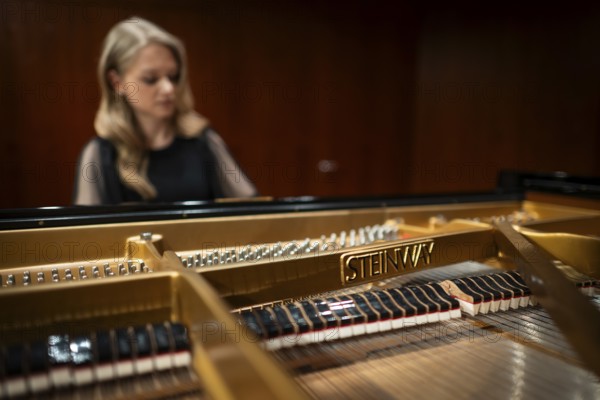 Young woman, pianist playing on a Steinway & Sons grand piano, Stuttgart, Baden-Württemberg, Germany