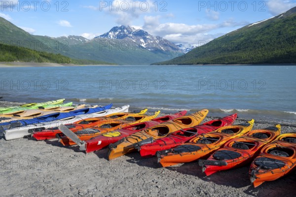 Colorful kayaks on lakeside, lake and mountains, Eklutna Lake, Chugach Mountains, Chugach State Park, Alaska, USA