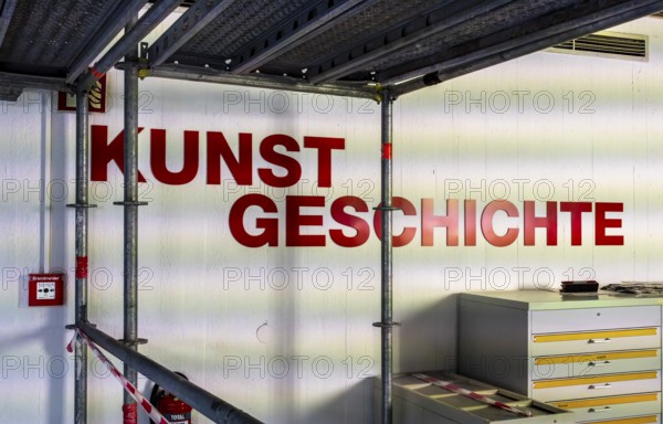 Technical University in Berlin, provisional information sheets and signs at an indoor construction site show the way towards the library, Berlin, Germany