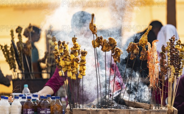 Vendor selling roasted meat at a stall in Bhogali Mela, ahead of the 'Magh Bihu' festival, in Guwahati, Assam, India on January 12, 2026. Magh Bihu, also called Bhogali Bihu, is Assam's harvest festival marking the end of the agricultural season and celebrated with feasts, community bonfires, and traditional food