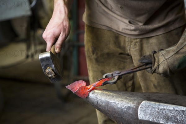 A blacksmith forging, working at the Ehnert forge in Dresden-Bühlau, Saxony, Germany