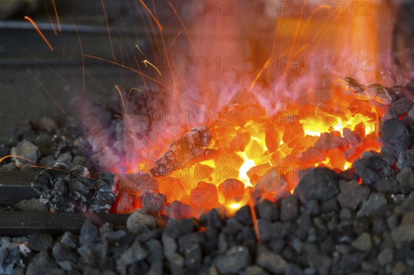 A blacksmith forging, working at the Ehnert forge in Dresden-Bühlau, Saxony, Germany