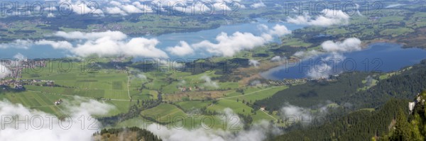 Panorama from Tegelberg, 1881m, of the cloud-covered Forggensee and Bannwaldsee, Ostallgäu, Bavaria, Germany