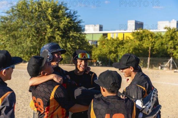 Young baseball players enjoying a moment of camaraderie and success, smiling and embracing after a game, demonstrating teamwork and sportsmanship on the field with their casual sportswear