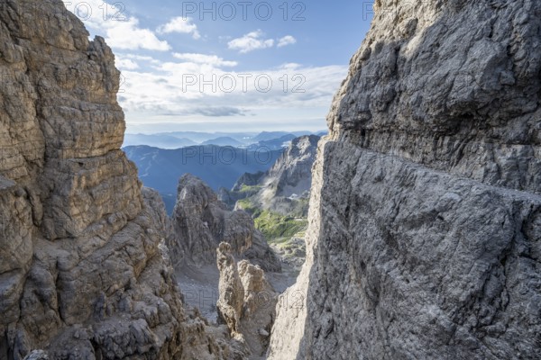 View from the Bocca degli Armi gap, mountaineers on a rock band on the Via Ferrata Bocciere Centrale via ferrata, Brenta Mountains, Brenta-Adamello Natural Park, Trentino, Italy