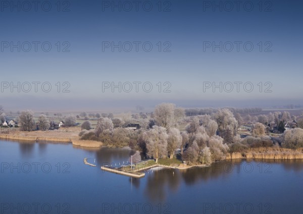 Lembruch, Lower Saxony, Germany, aerial view of one of the eastern shore of Eickhöpen am Dümmer See, surrounded by autumnal trees and clear skies, Dümmer nature park Park, Lembruch, Lower Saxony, Germany