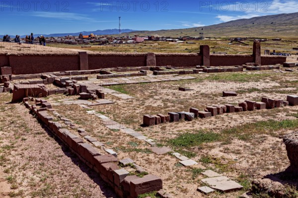 Historic stone ruins in an archaeological site in front of an expansive sky horizon, The archaeological site with the ruins of Tiwanaku in Bolivia