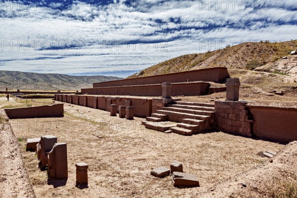Ancient ruins and stone structures in a vast landscape under a cloudy sky, The archaeological site with the ruins of Tiwanaku in Bolivia
