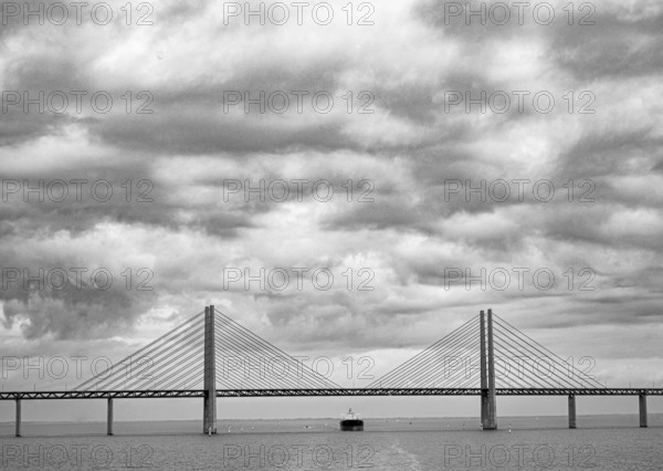 Dramatic clouds in the sky over the Öresund Bridge between Malmö and Copenhagen, painted in black and white, monochrome, Øresund, Skane län, Sweden