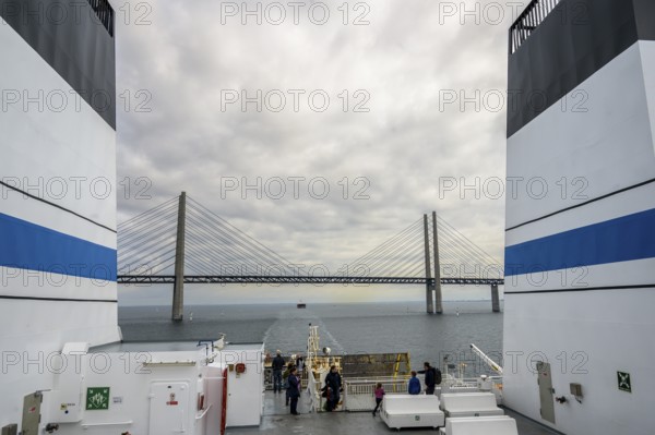 View from a ship of the Øresund bridge under a cloudy sky, wind turbines in the sea under a vast, cloudy sky, Malmö, Øresund, Skane län, Sweden