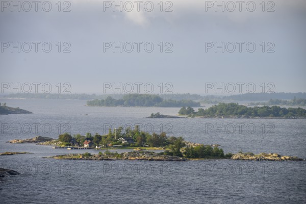 Small islands in the sea under a cloudy sky, calm and peaceful atmosphere, Aland Archipelago, Finland