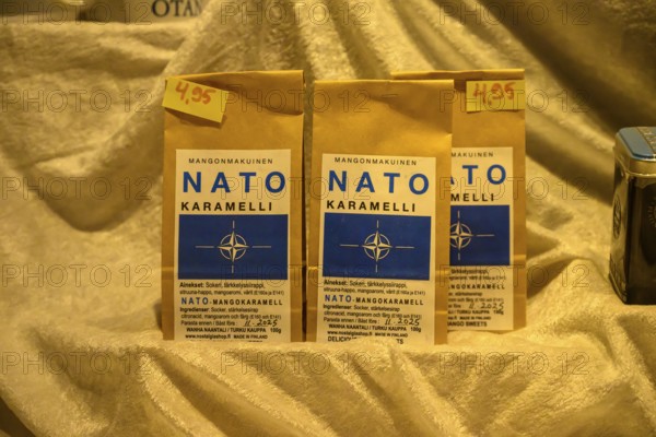 Street scene in the old town of Naantali, NATO caramel packaging boinbons with price tags on golden cloth in a window display, Naanatali, Varsinais-Suomi, Finland