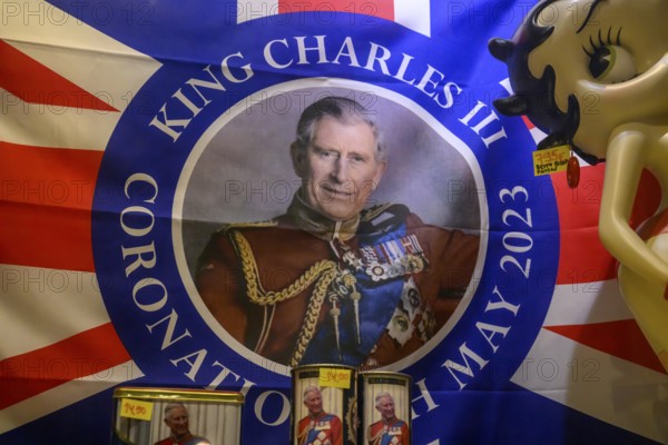 Street scene in the old town of Naantali, colorful flag with portrait of King Charles III and coronation motif, window display, Naanatali, Varsinais-Suomi, Finland