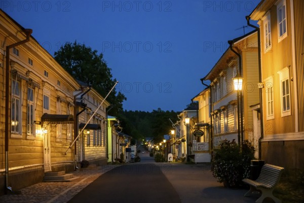 Street scene in the old town of Naantali at night with warmly lit houses, Naanatali, Varsinais-Suomi, Finland