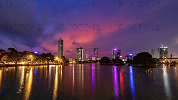 City landscape at night with impressive lights and colorful sky above the water surface, the skyline of Colombo Sri Lanka at night
