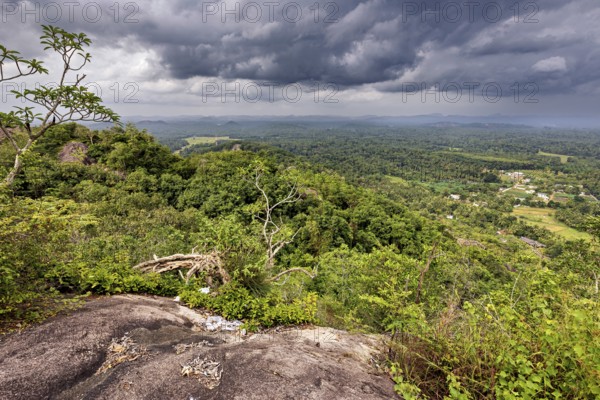 Far-reaching view of green forests and valleys under a dramatic cloudy sky, The landscape in the mountains near Colombo Sri Lanka