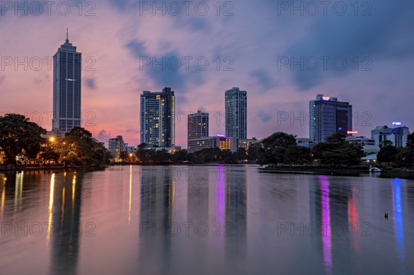 City view at dusk with illuminated skyscrapers and colorful reflections in the river, the skyline of Colombo Sri Lanka at night