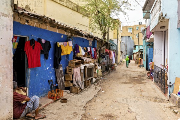 Alley with colorful walls and hung clothes in an urban setting, people in the streets of Slave Island in Colombo Sri Lanka