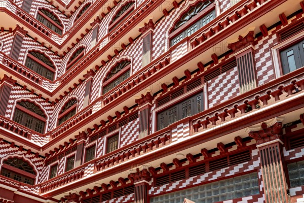 Detailed view of a red building façade with symmetrical window and pattern design, the old town with the red mosque in Colombo Sri Lanka