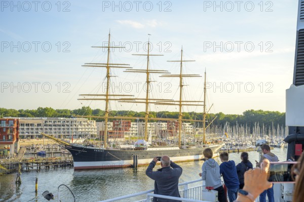 A large sailing ship the legendary 4 Mastbark Passat a flying P-liner with people taking photos catches the eye in the harbor, Lübeck-Travemünde, Schleswig-Holstein, Germany