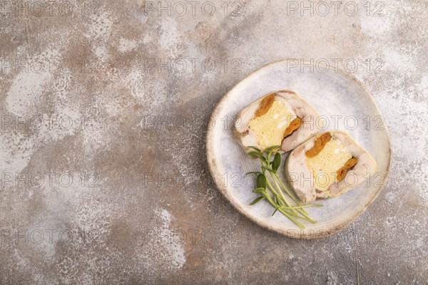 Chicken, egg and dried apricot meatloaf, microgreen on brown concrete background. top view, flat lay, copy space