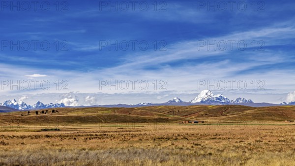 Wide hilly landscape with mountains and a cloudy sky, The Altiplano landscape in the Andes of Bolivia