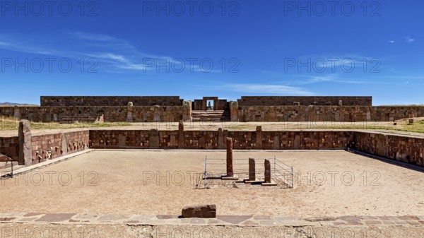 Open ruins with stone walls and sandy soil under a clear blue sky, The archaeological site with the ruins of Tiwanaku in Bolivia