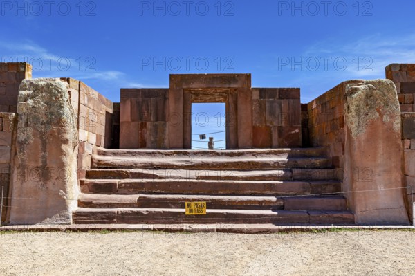 Stone architecture with stairs and entrance surrounded by ruins under blue skies, The archaeological site with the ruins of Tiwanaku in Bolivia