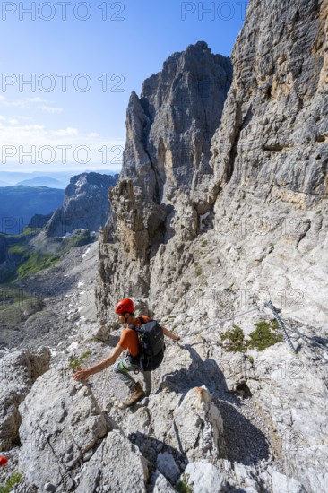 Climbers on the Via Ferrata Bocciere Centrale via ferrata, spectacular mountain landscape with steep cliffs and rock towers, Brenta Mountains, Parco Naturale Brenta-Adamello, Trentino, Italy