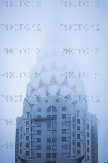 The Crysler Building tower in fog, New York, USA