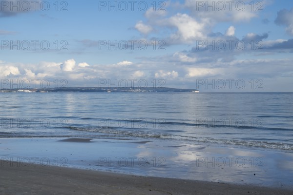 View across the Baltic Sea towards chalk coast, beach, sky with white clouds, Binz, seaside resort, island of Rügen, Mecklenburg-Western Pomerania, Germany