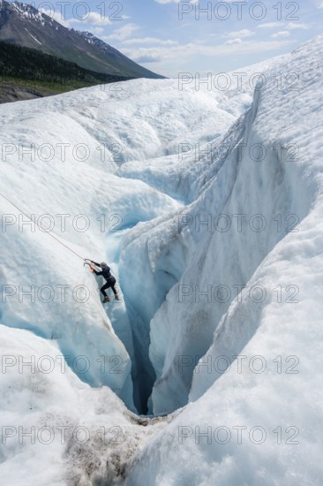 Ice climbers in an ice canyon, Root Glacier, Wrangell St. Elias National Park, Alaska, USA