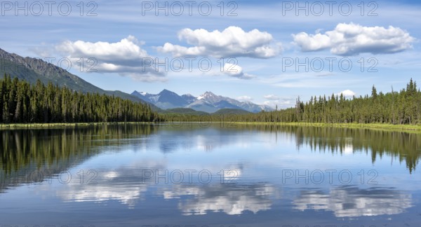 Mountains are reflected in idyllic Crystal Lake, McCarthy Highway, Wrangell St. Elias National Park, Alaska, USA