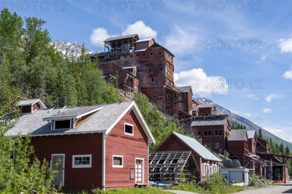 Red Kennicott buildings in front of mountainous landscape, Kennicott Concentration Mill to extract copper from quarried rock, Historic Kennecott Copper Mine, National Historic Landmark, Wrangell St. Elias National Park, Alaska, USA