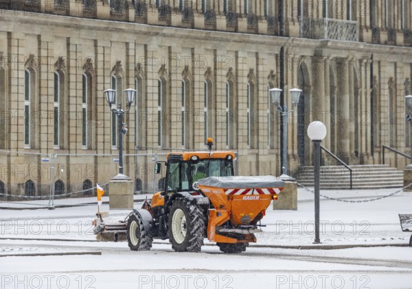 Winter in Stuttgart. There is a closed blanket of snow in the city center. Winter cleaning service on Schlossplatz in front of the New Palace. Roads and paths are freed from snow and sprinkled. Stuttgart, Baden-Württemberg, Germany