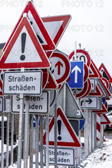 Storage for traffic signs in the yard of a road maintenance department, various signs with commandments and prohibitions, information about dangers, road traffic