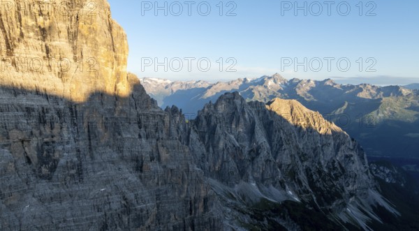 Aerial view, alpine panorama, rocky peaks at sunrise with alpine glow, picturesque mountain landscape, Brenta Dolomites, Trentino, Italy