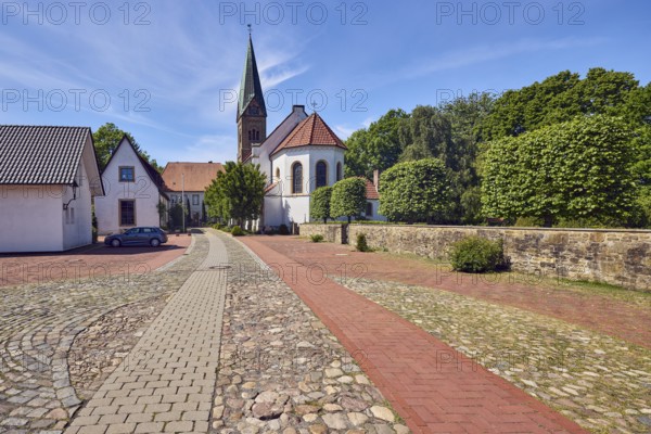 St. Paul's Church, general architecture, building, concrete paving stone walkway, paving stones and natural stones, sandstone wall, trees, blue sky, cirrus clouds, Am Burghof, district of Vörden, Neuenkirchen-Vörden, Vechta district, Lower Saxony, Germany