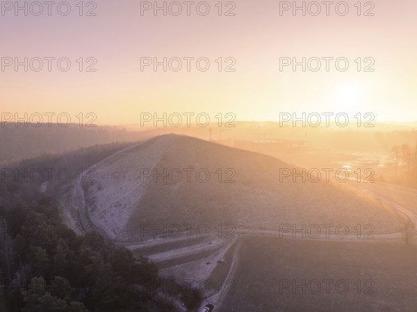 Natural hill in the soft light of a bright winter morning, old deposit, construction site for PV open space plant, Lindenrain, Calw, Germany