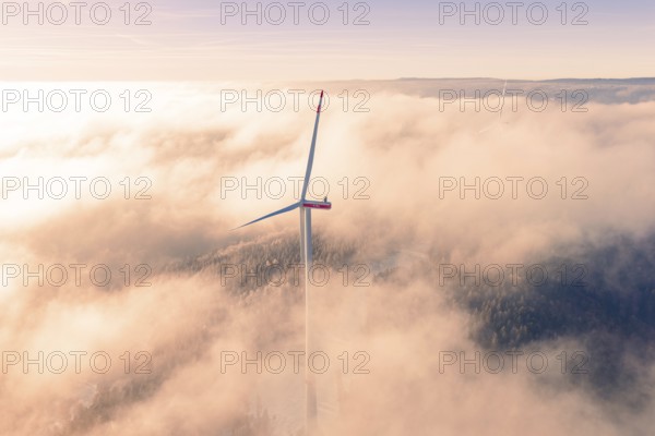 Wind turbine juts out of thick clouds, surrounded by foggy landscape, Bad Wildbad, Calw district, Black Forest, Germany