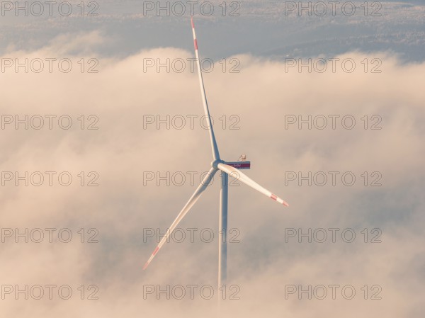 Large wind turbine in a sea of clouds surrounded by soft morning light, Bad Wildbad, Calw district, Black Forest, Germany